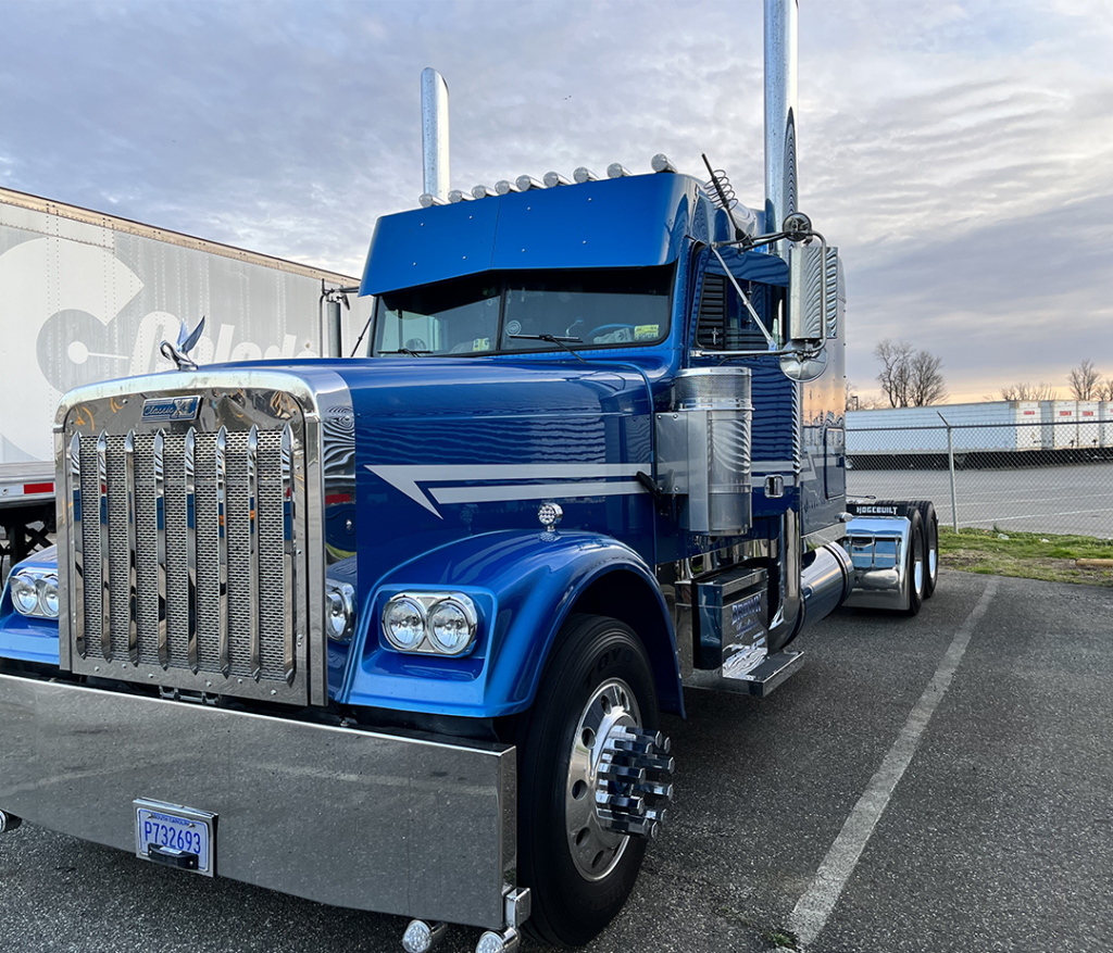Blue commercial semi-truck parked outside FAST ACTION Body Repair shop awaiting Fleet Truck Repair NYC service